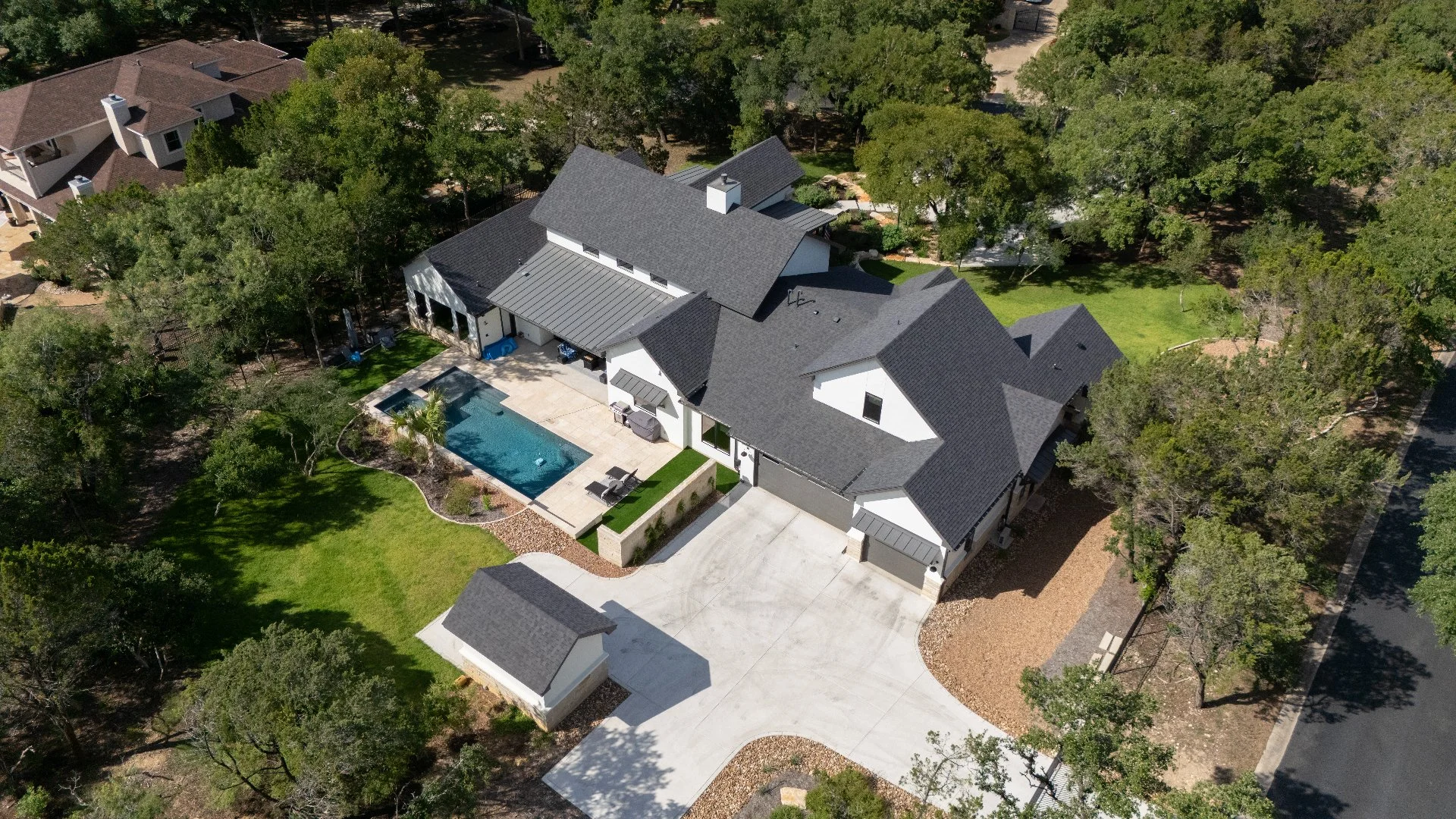Landscape bed with mulch and trimmed plants.