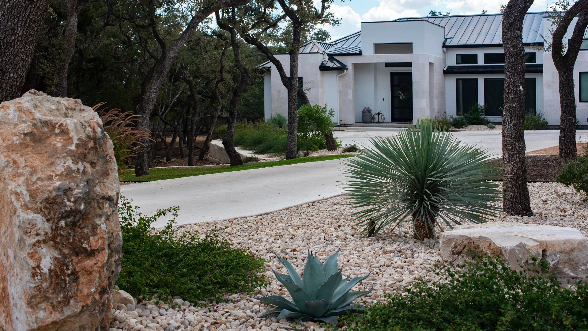 Yard with landscape beds and green grass in New Braunfels, TX.