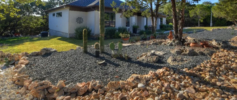 Landscape in New Braunfels, TX, with rocks and cacti.