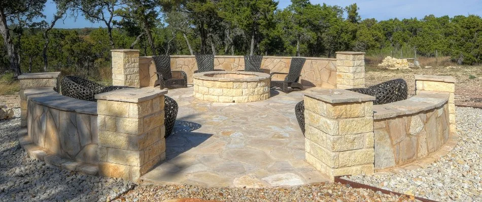 Paver patio with seating walls and a fire pit in New Braunfels, TX.