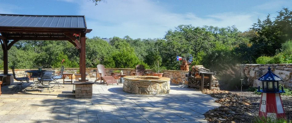 Fire pit in New Braunfels, TX, beside a pavilion.