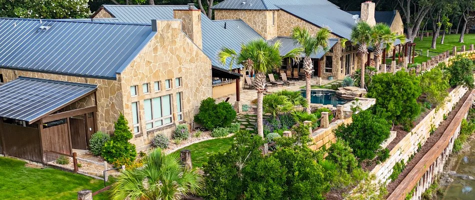 Lush trees and shrubs outside a house in Gruene, TX.