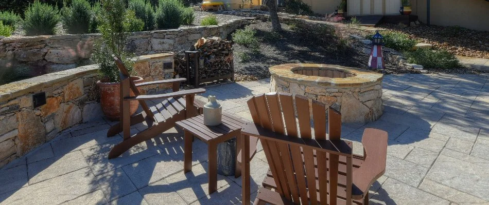 Patio in New Braunfels, TX, with fire pit and seating wall.