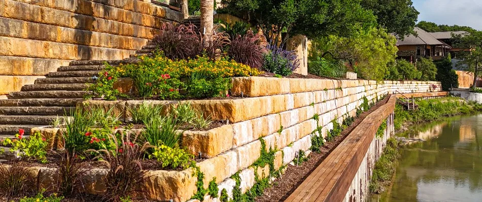 Retaining walls in New Braunfels, TX, with raised planter beds.