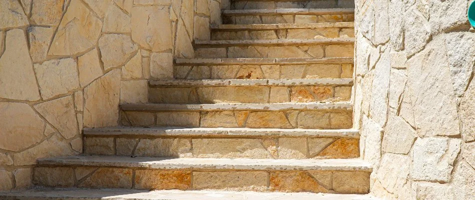 Sandstone outdoor steps in New Braunfels, TX, with retaining walls.